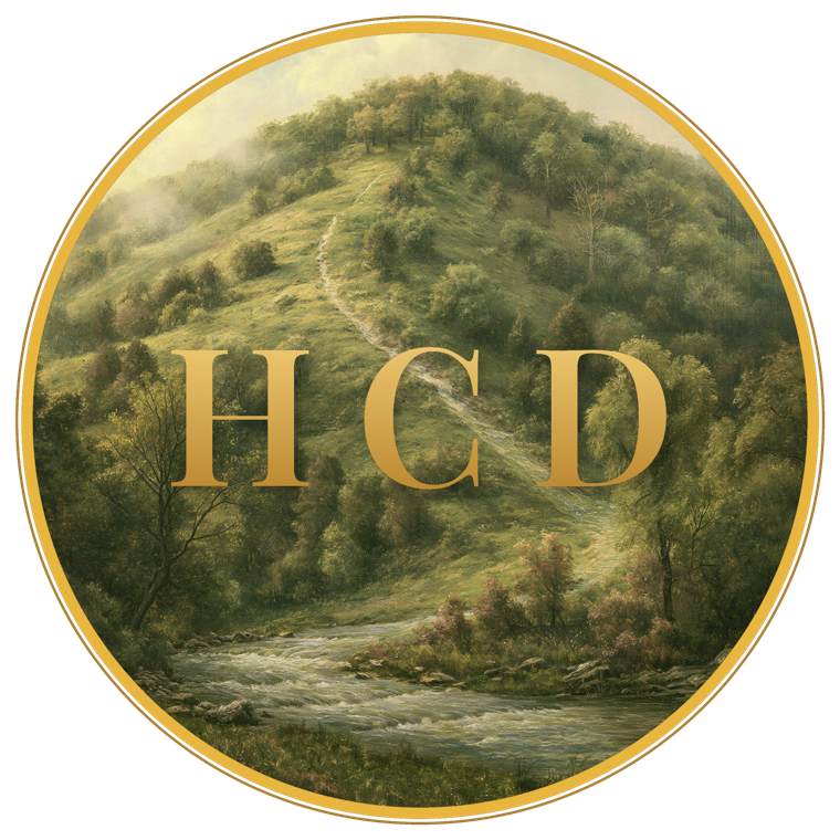 Hilltop Creek Designs — an Ozark hilltop with a creek widening as it flows down, the gold letters H C D set in the scene